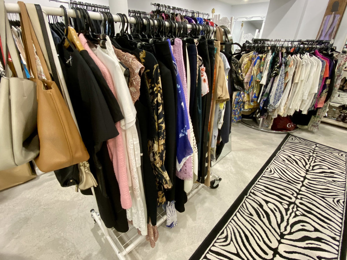 Handbags and designer clothing on the rails at Secondo