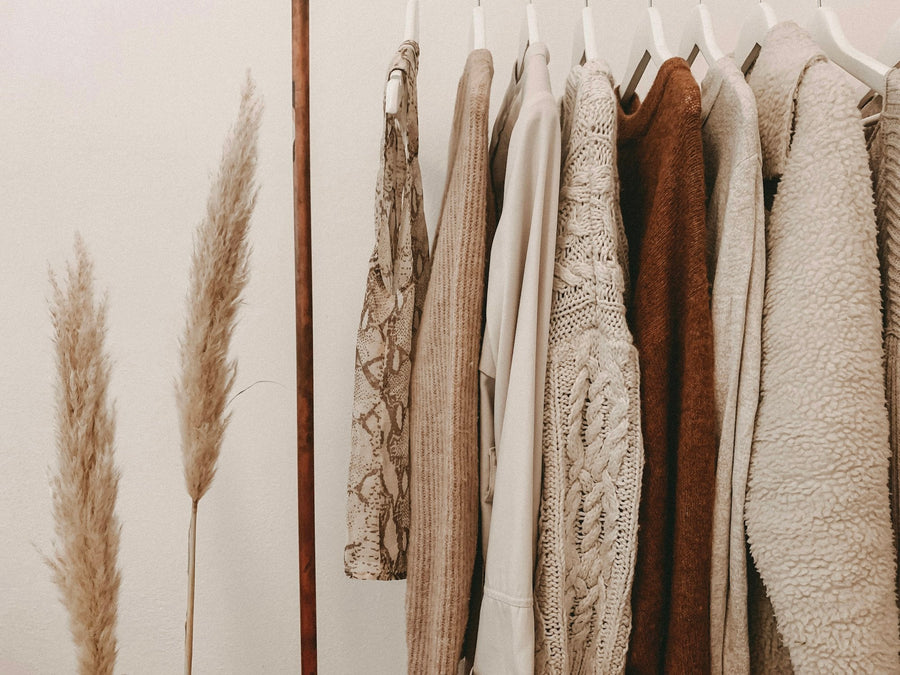 Neutral designer pieces on a boutique clothing rail