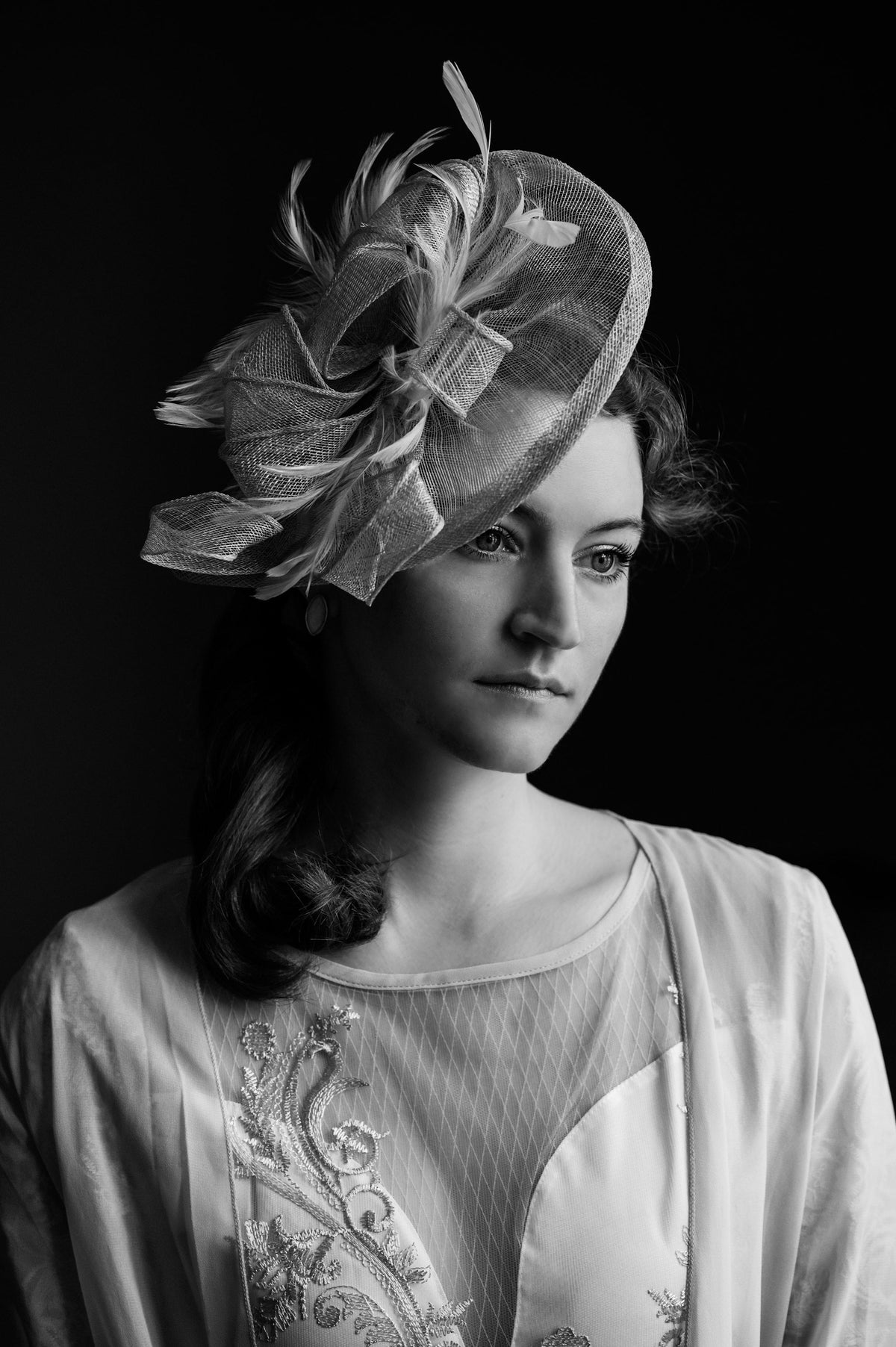 Black and white portrait of a woman wearing a fascinator