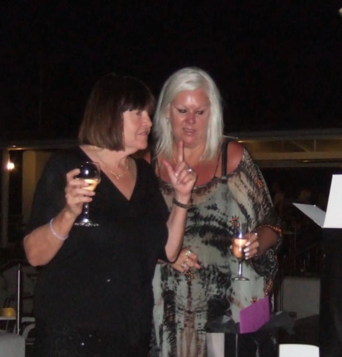 Robyn and Kim Robertson, glasses raised